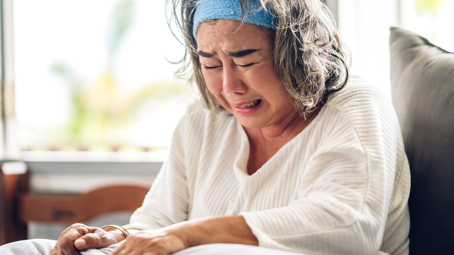 Photo of a grieving woman crying alone