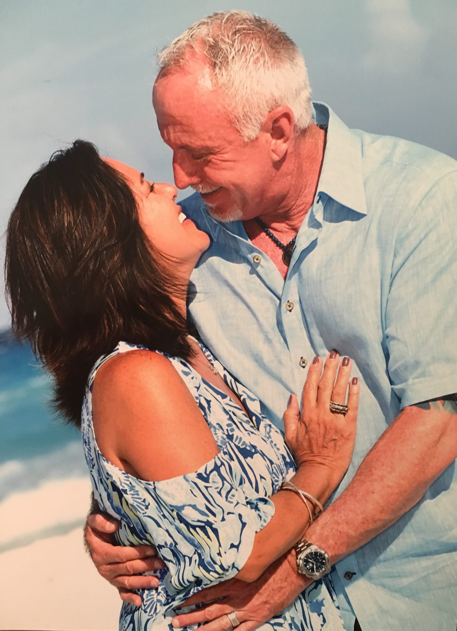 Johnny and Vera walking hand in hand on the beach, smiling together