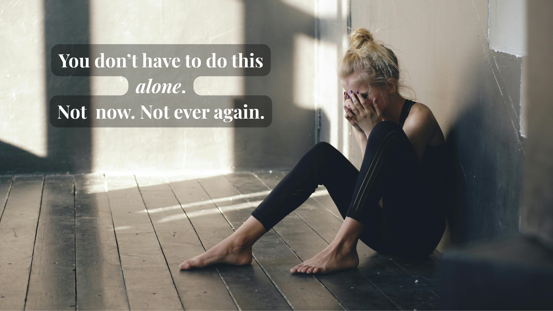 Overwhelmed woman sitting in the corner of the room, symbolizing caregiver isolation